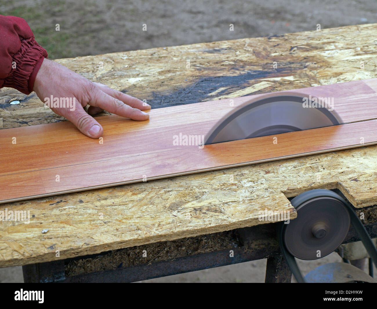 Sawing laminate floorboards by homemade circular saw Stock Photo