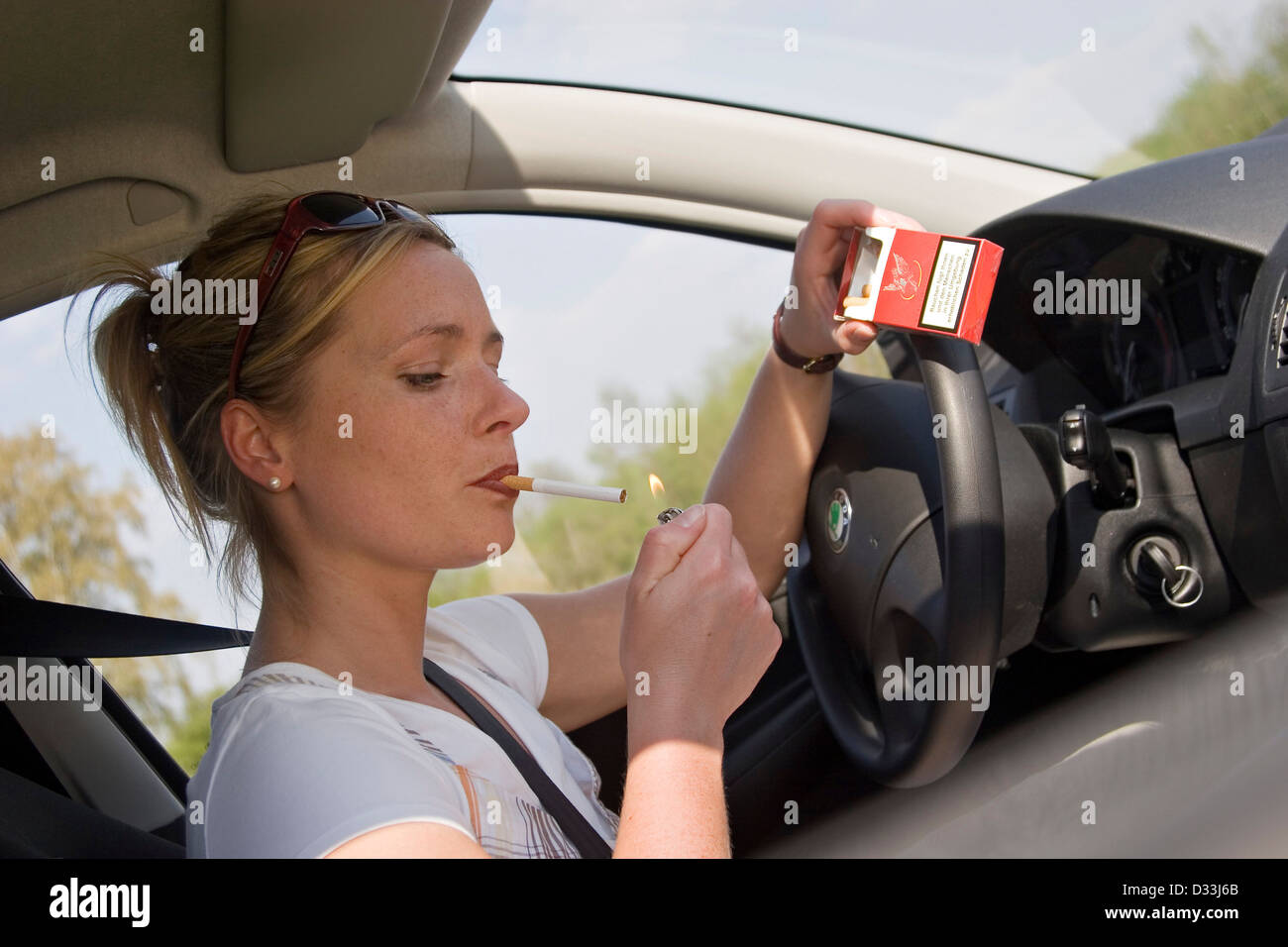 Woman smoking during the car ride Stock Photo, Royalty Free Image