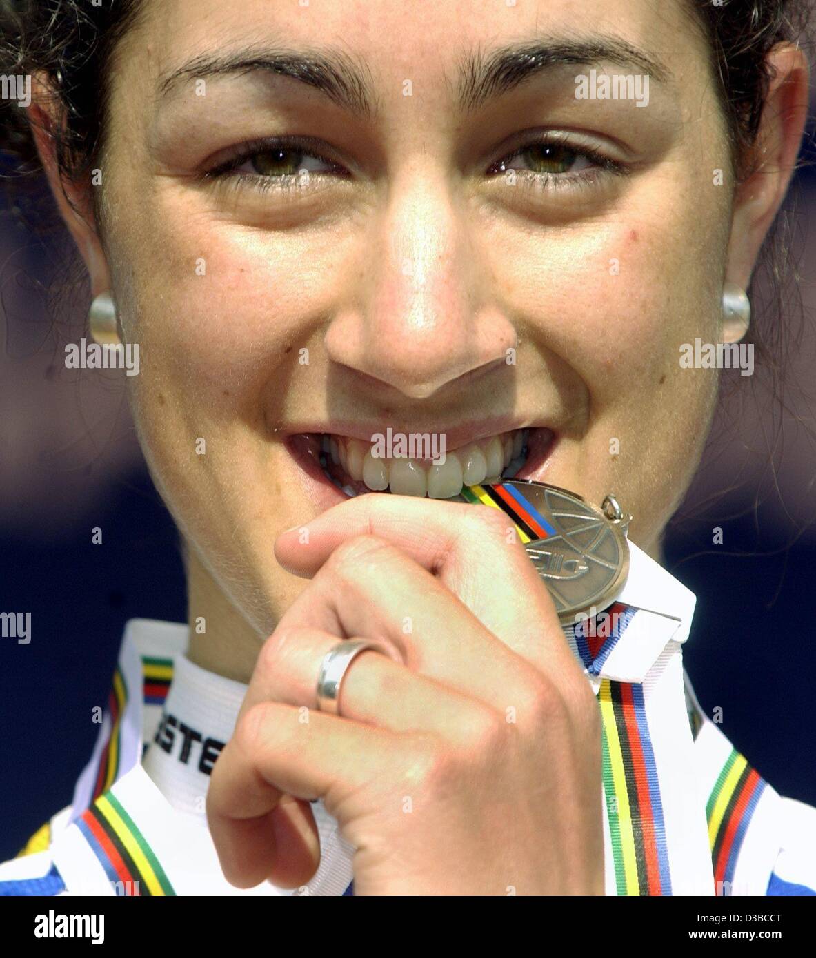 (dpa) - German cyclist Claudia Stumpf shows off her silver medal after the ...