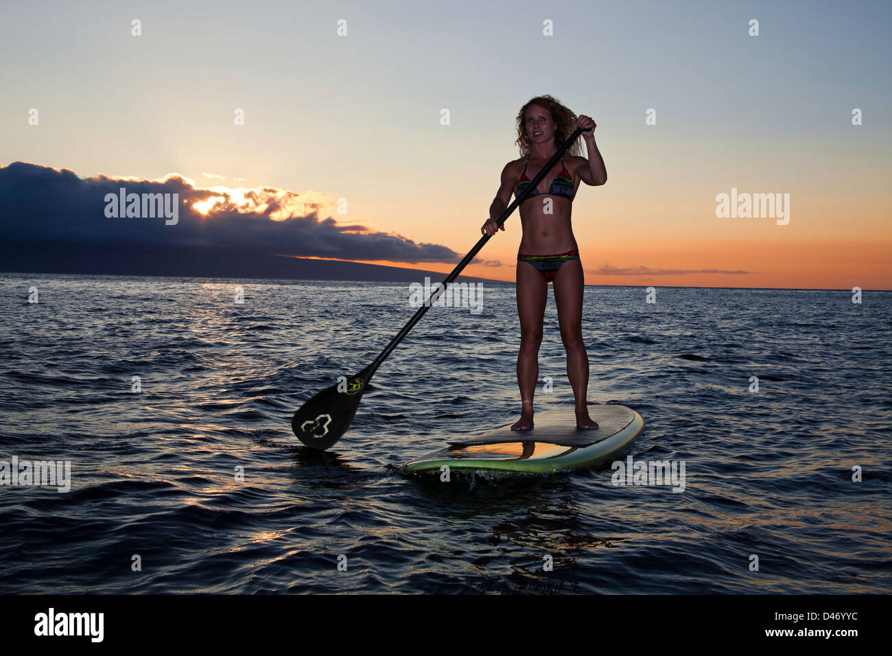 Surf Instructor Tara Angioletti At Sunset On A Stand-up Paddle Board 