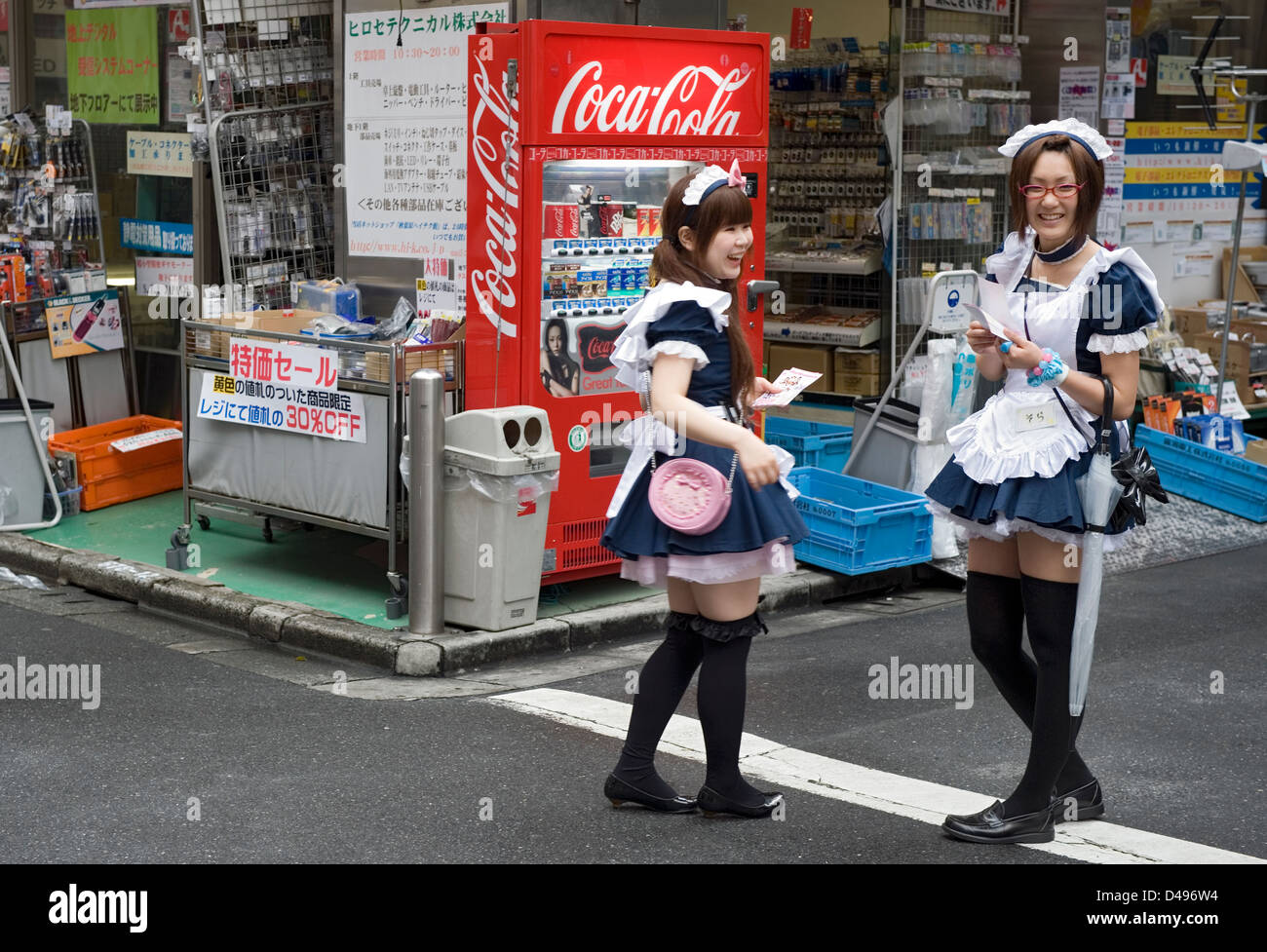 Girls dressed in French maid costumes handing out discount coupons
