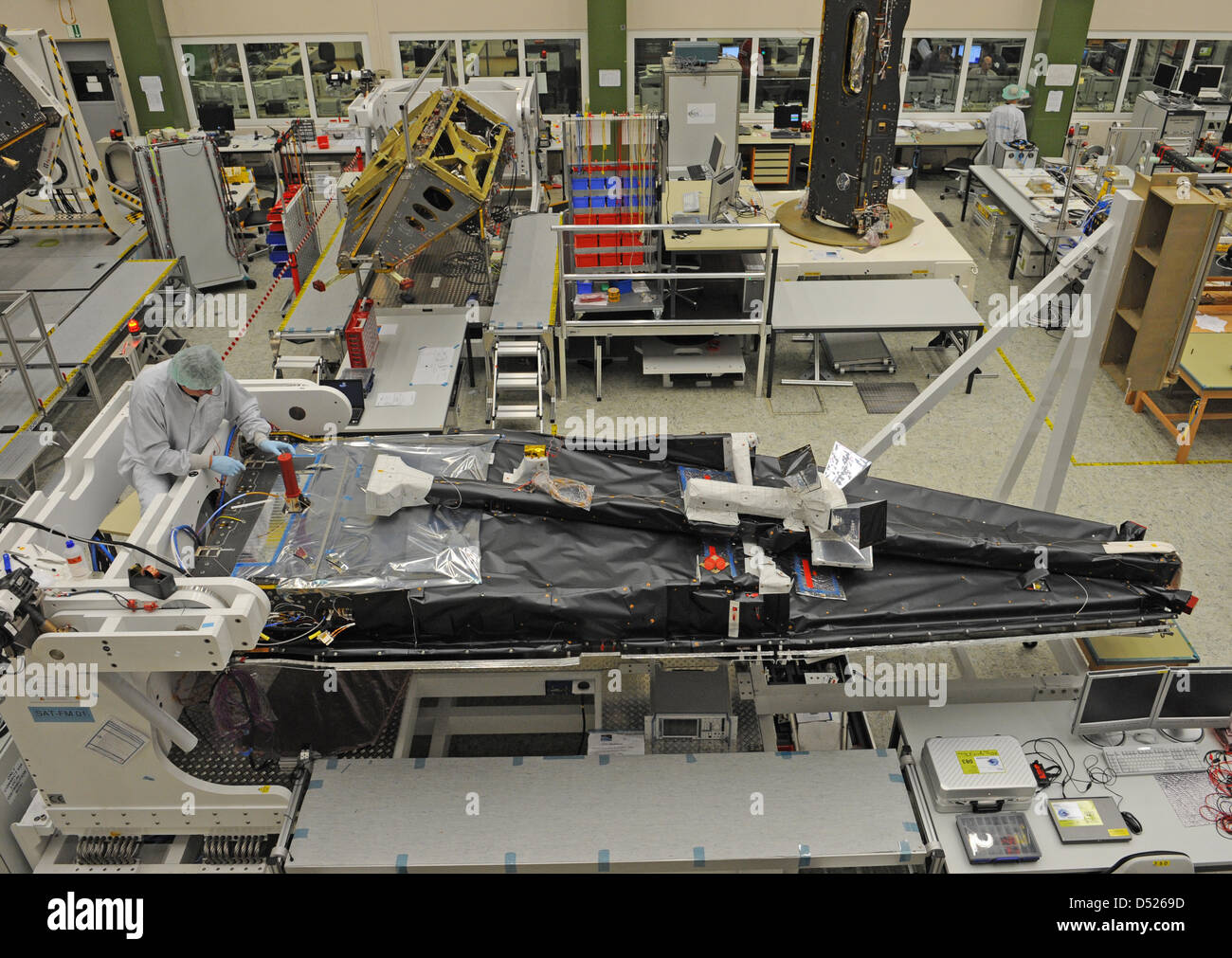 An employee of the satellite manufacturer Astrium works on one of the