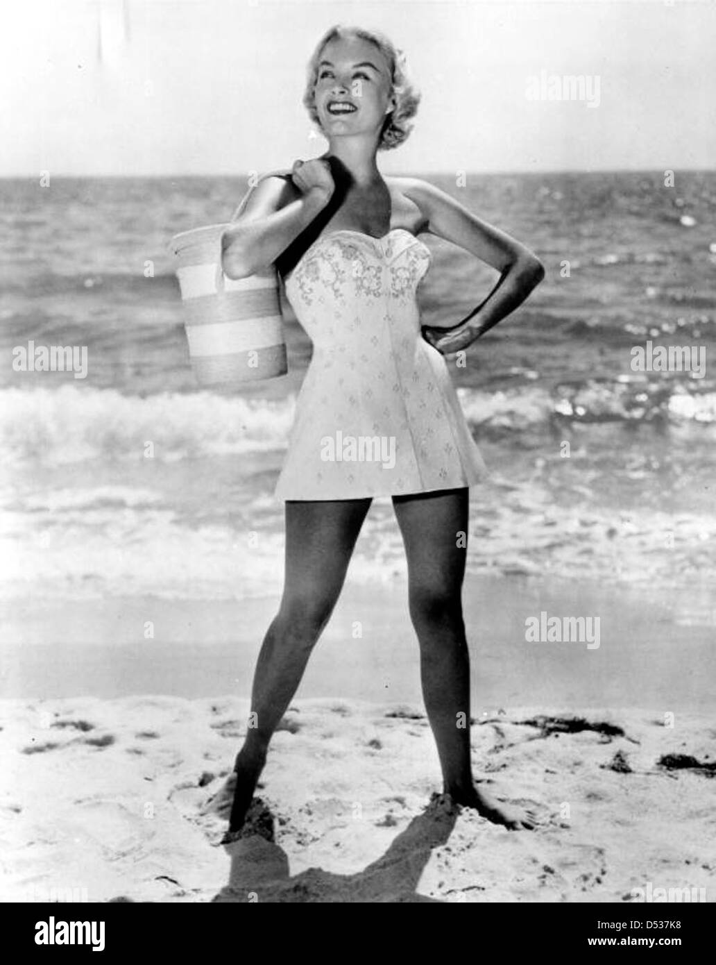 A fashion model in swimsuit poses on the beach Stock Photo, Royalty