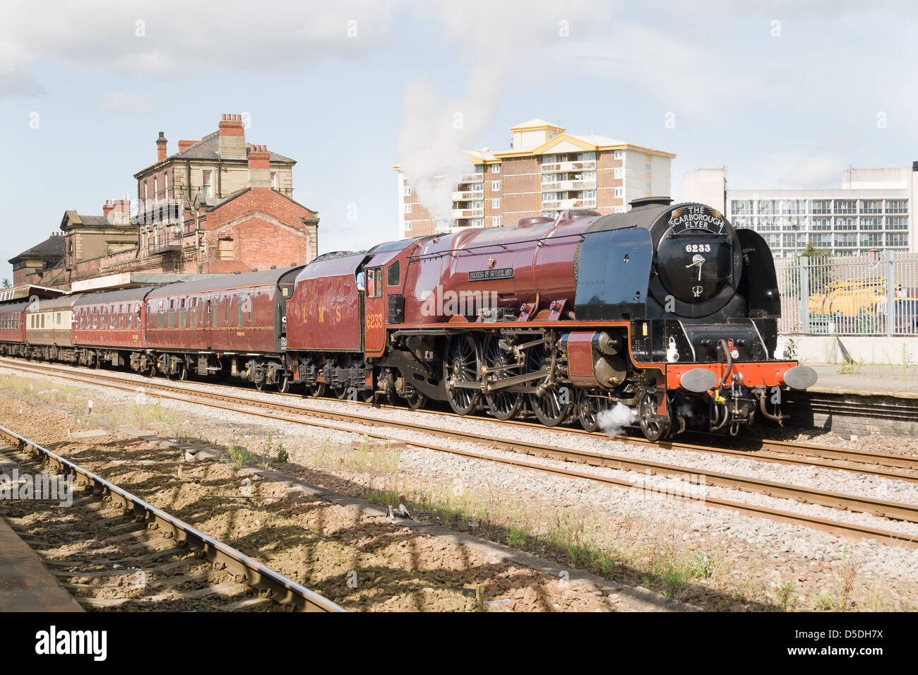 A steam pulling a passenger train on the main line at Stock