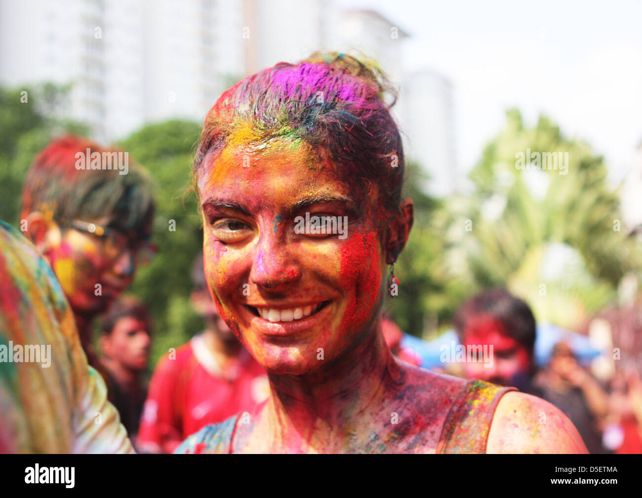 A tourist face smeared with colored powder, celebrates Holi festival at Shree Lakshmi Narayan Temple in Kuala Lumpur, Sunday, March. 31, 2013. - kuala-lumpur-malaysia-31st-march-2013-a-tourist-face-smeared-with-D5ETMA
