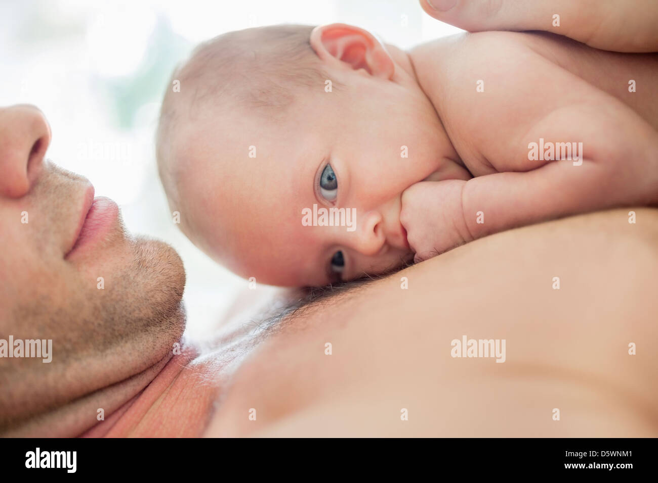 father-cradling-newborn-baby-on-chest-D5