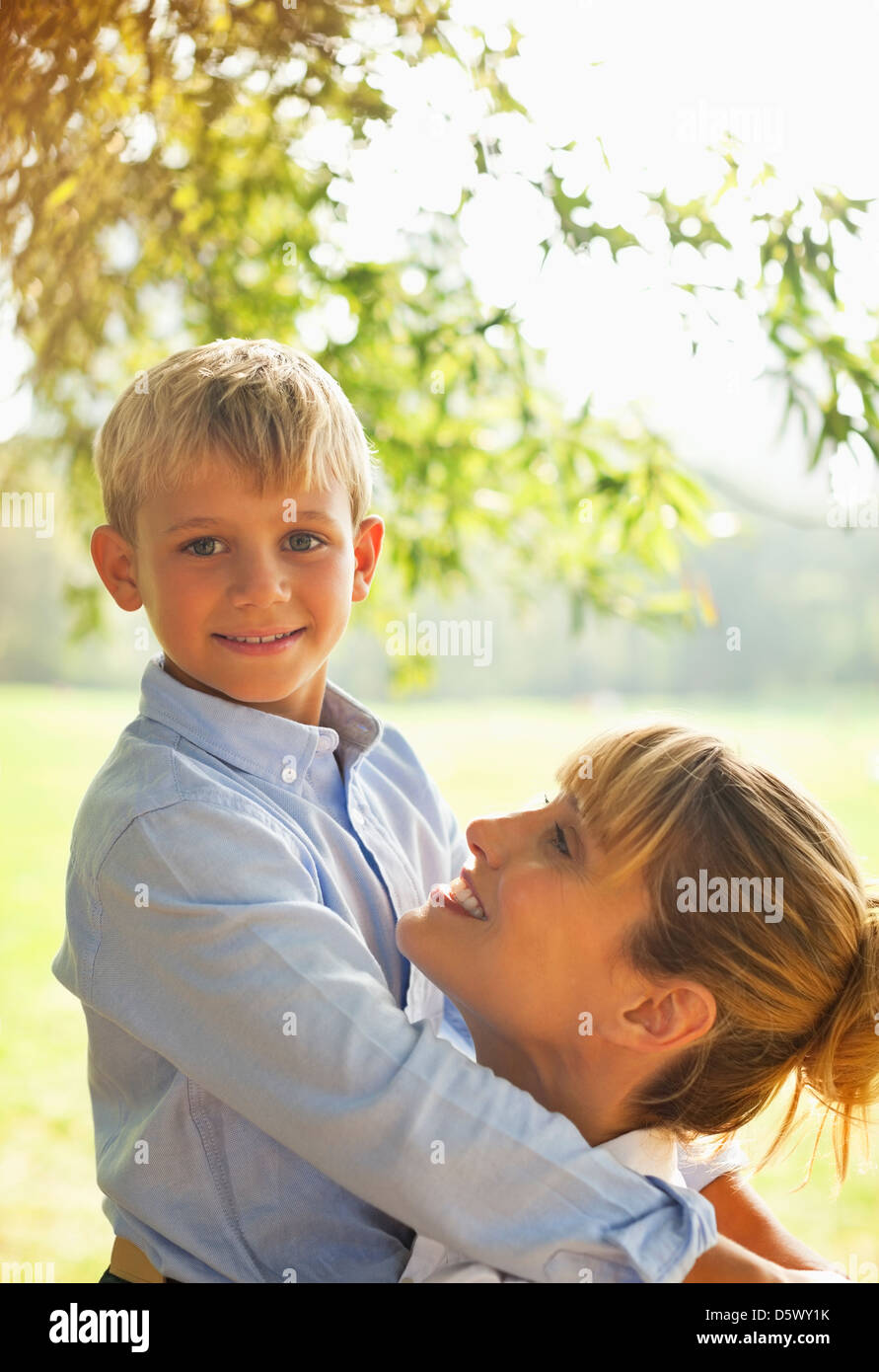 Mother And Son Hugging In Park Stock Photo Alamy