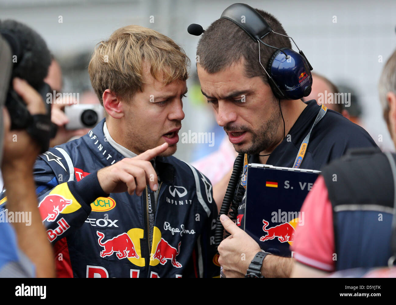 German Formula One driver Sebastian Vettel (L) and his race engineer