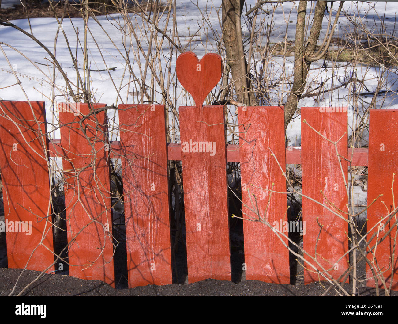 red-wooden-fence-with-carved-out-heart-o
