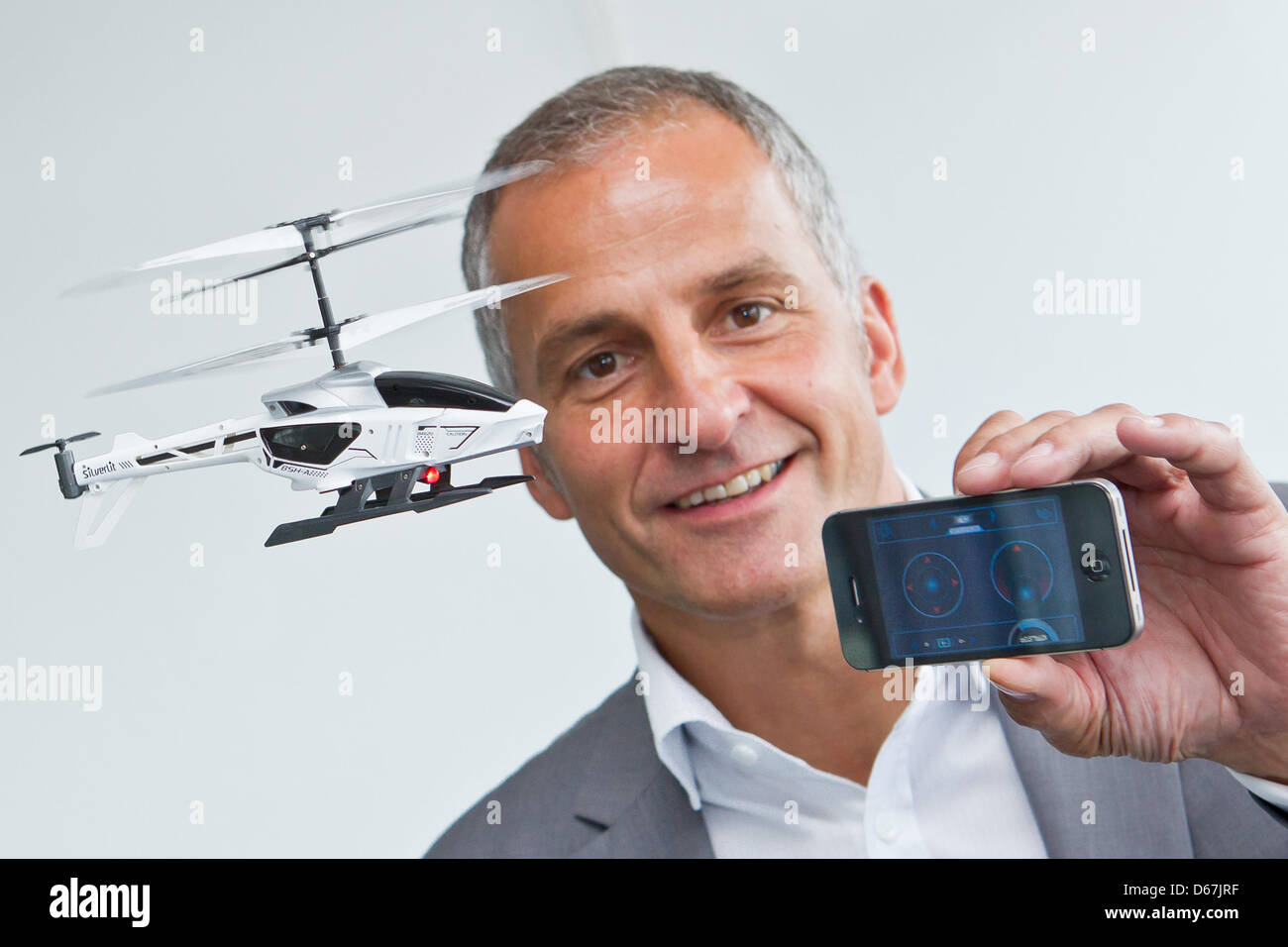 Stock Foto - The head of the Vedes AG, <b>Achim Weniger</b>, presents a toy ... - the-head-of-the-vedes-ag-achim-weniger-presents-a-toy-helicopter-by-D67JRF