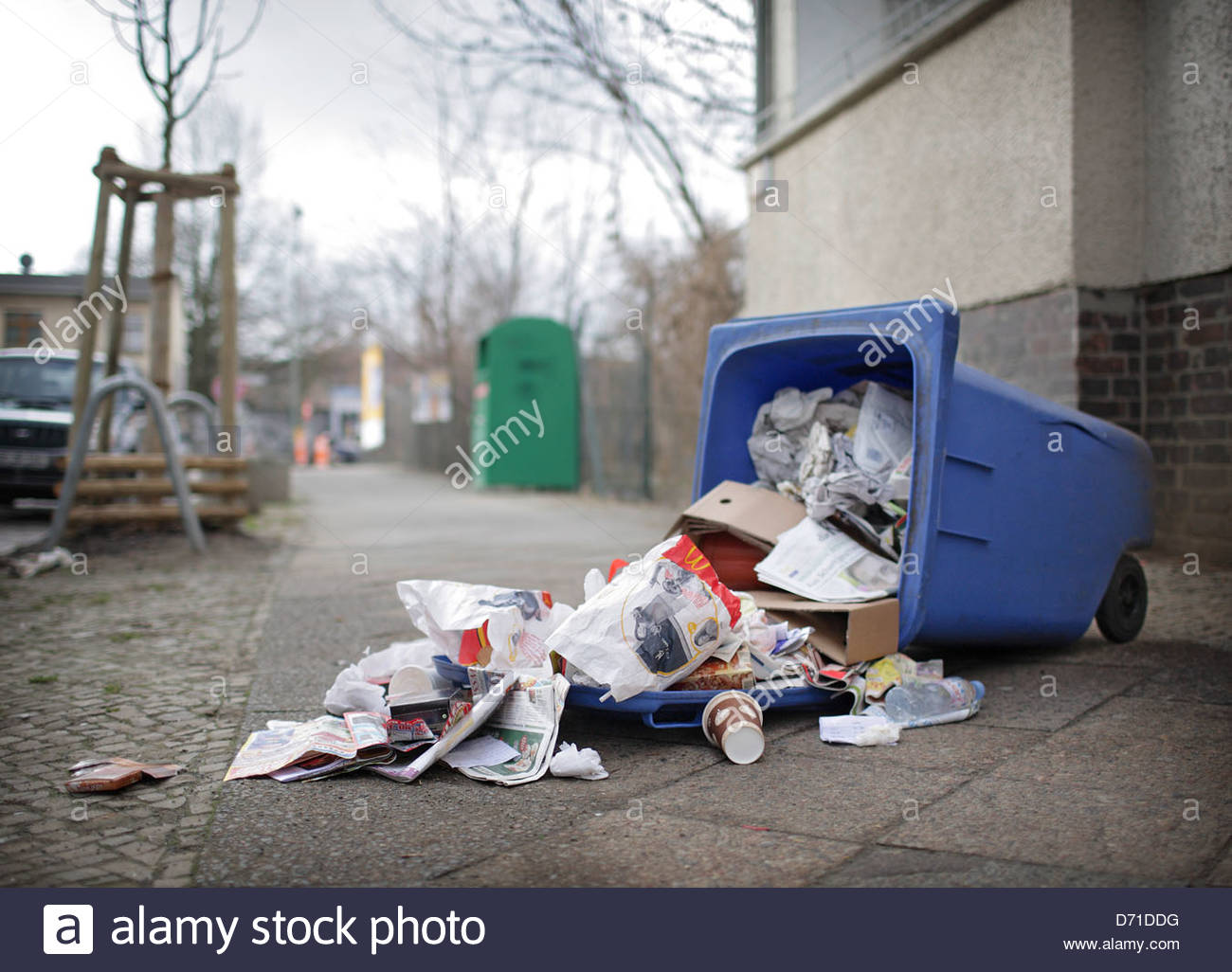Fallen garbage bin in the street Stock Photo, Royalty Free Image