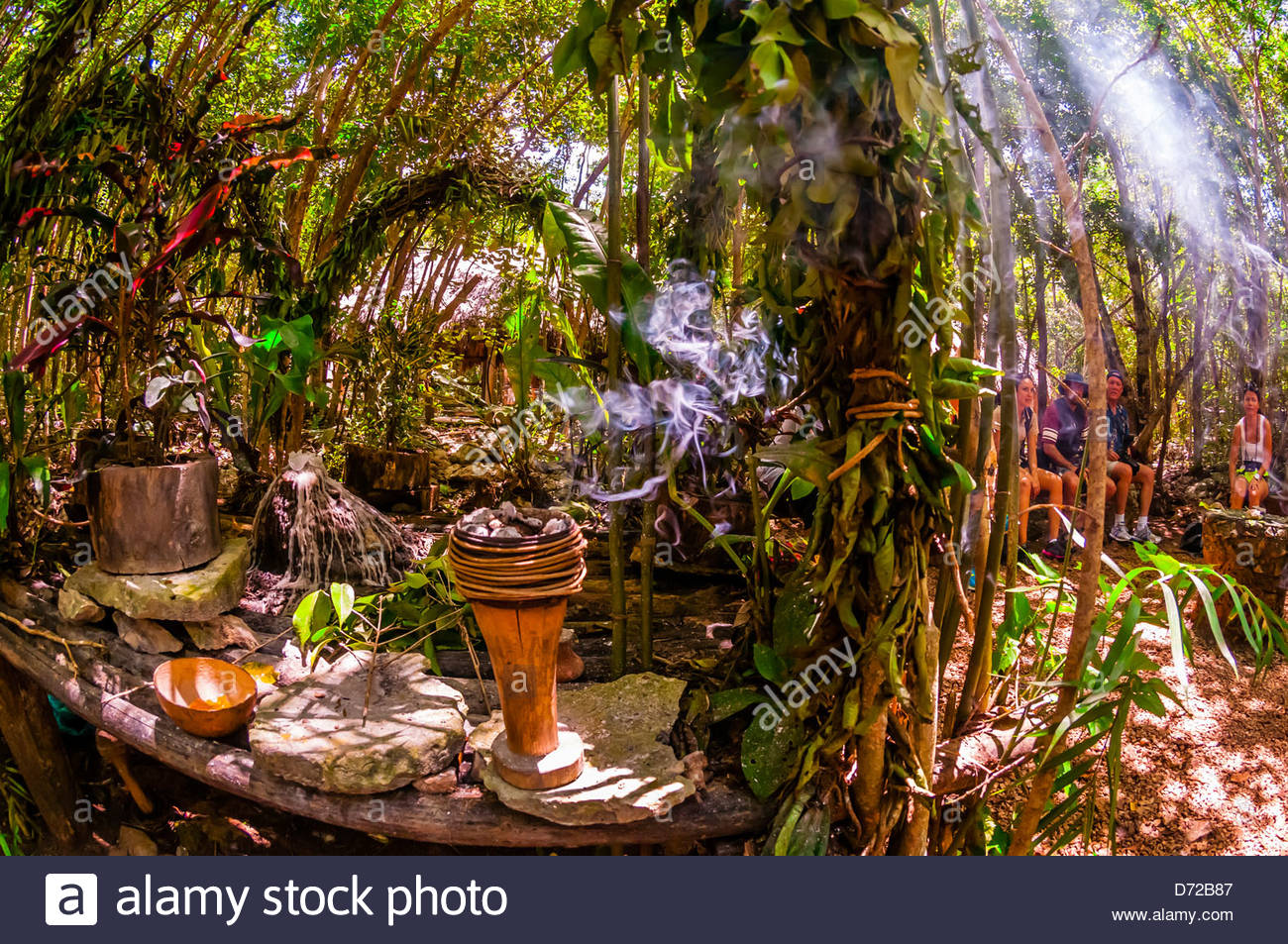 A Mayan shaman performing a purification ceremony in the jungle, near