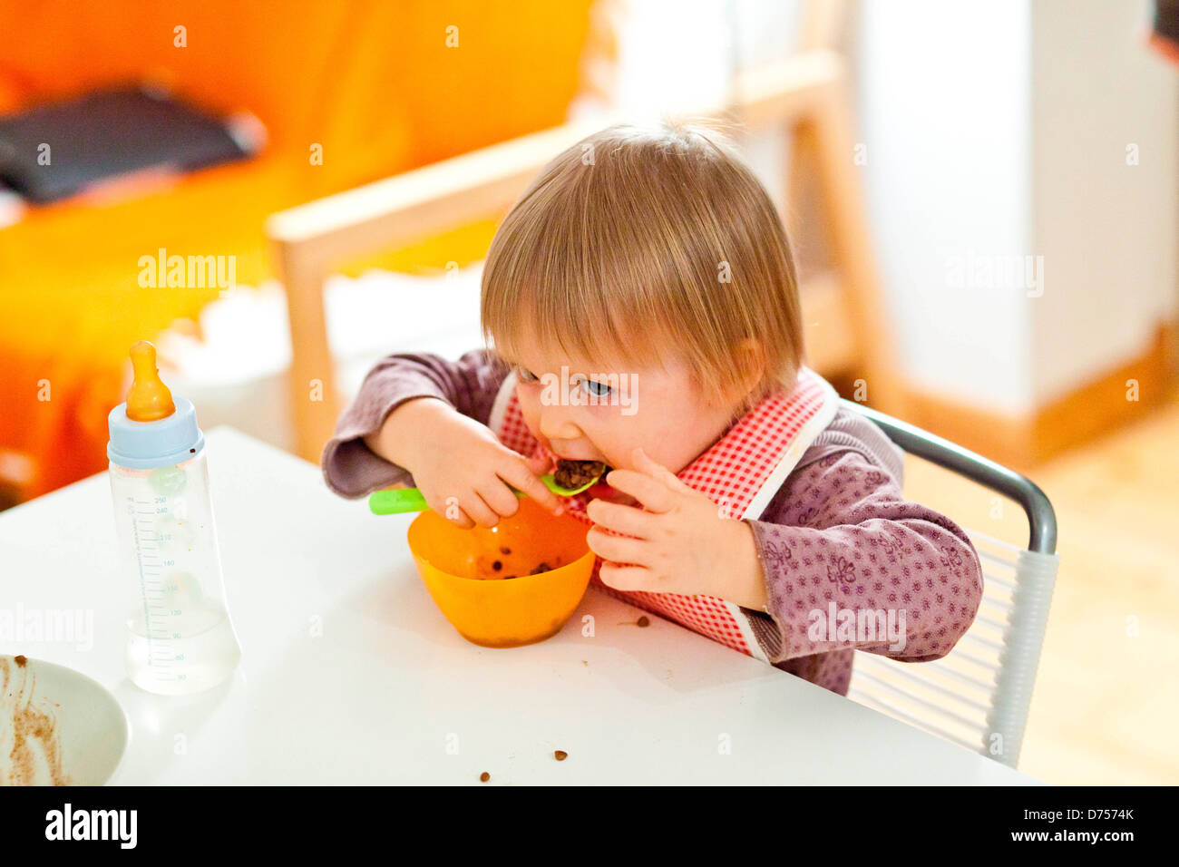 18 Month Old Baby Girl Eating Alone. Independence Training Stock Photo