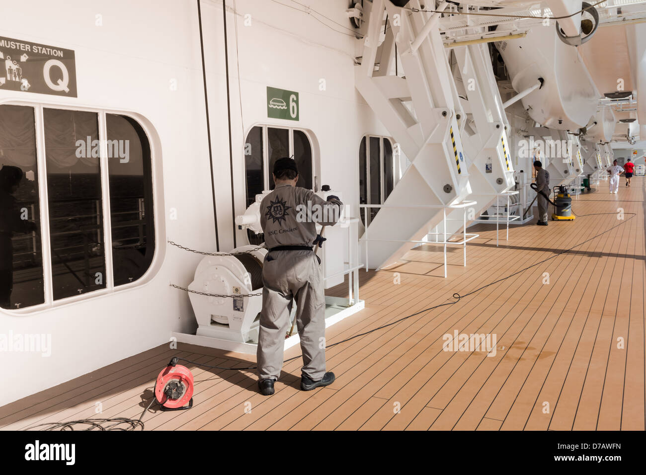 Crew cleaning boat deck of cruise ship MSC Armonia Stock Photo, Royalty