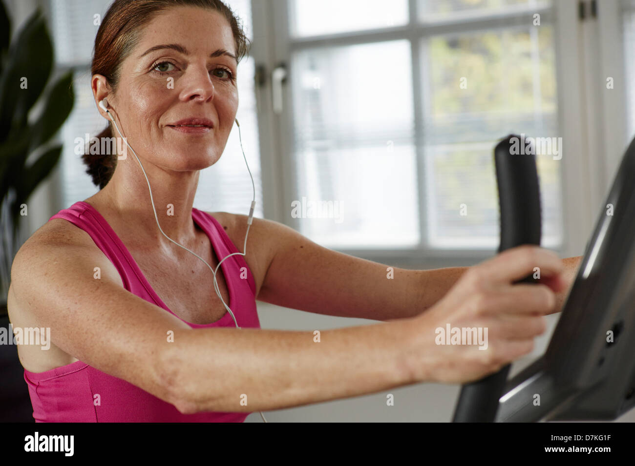 Germany Duesseldorf Mature Woman Exercising With Treadmill Smiling