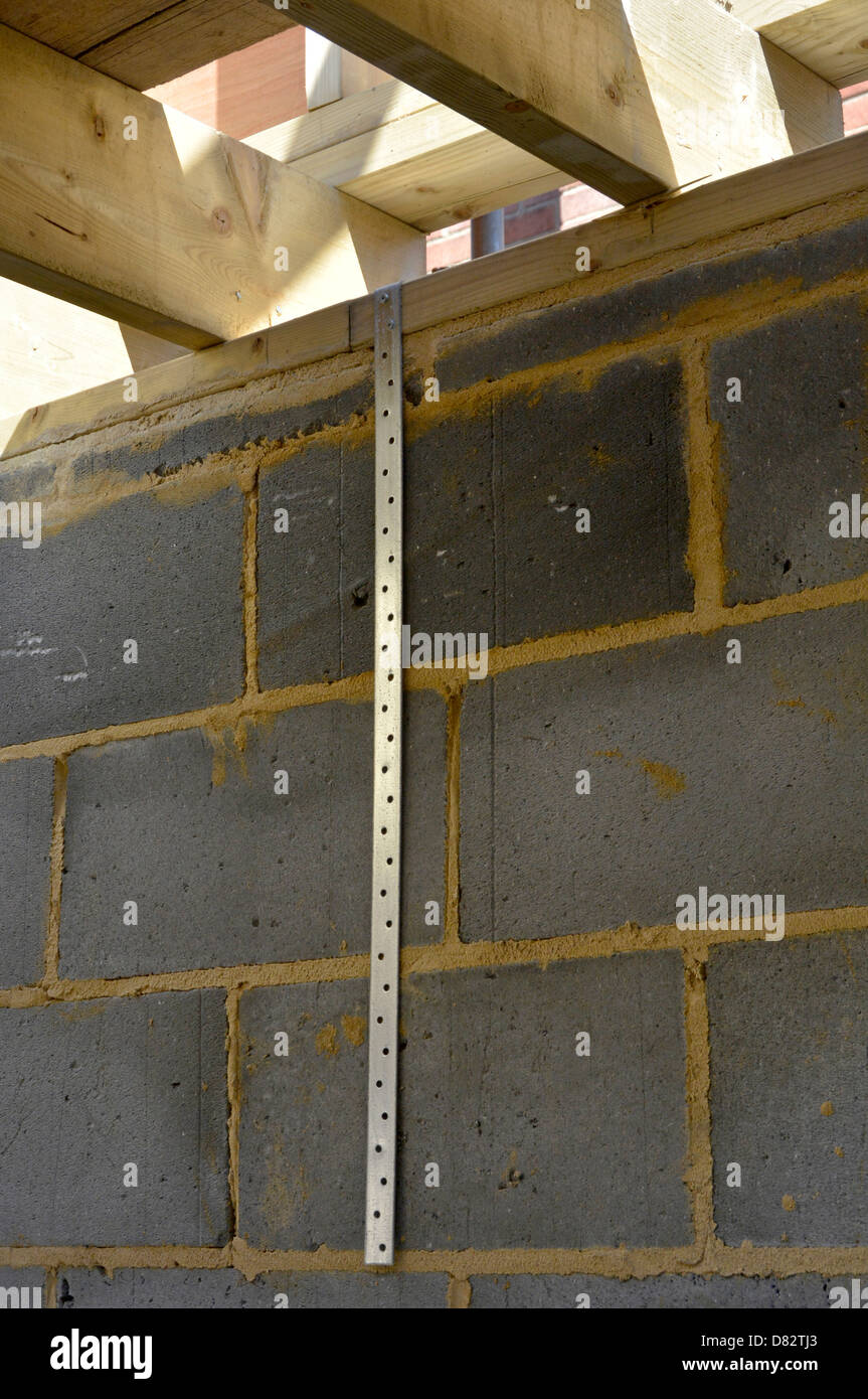 Galvanised steel holding down straps awaiting fixing to block walls Stock Photo, Royalty Free Galvanised steel holding down straps awaiting fixing to block walls Stock Photo, Royalty Free