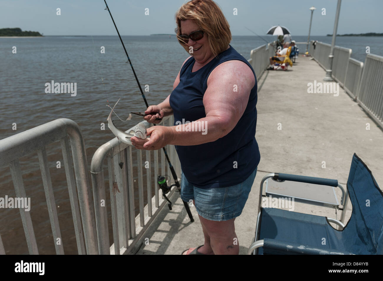 A woman fishing on the public pier at Cedar Key Florida on the Gulf