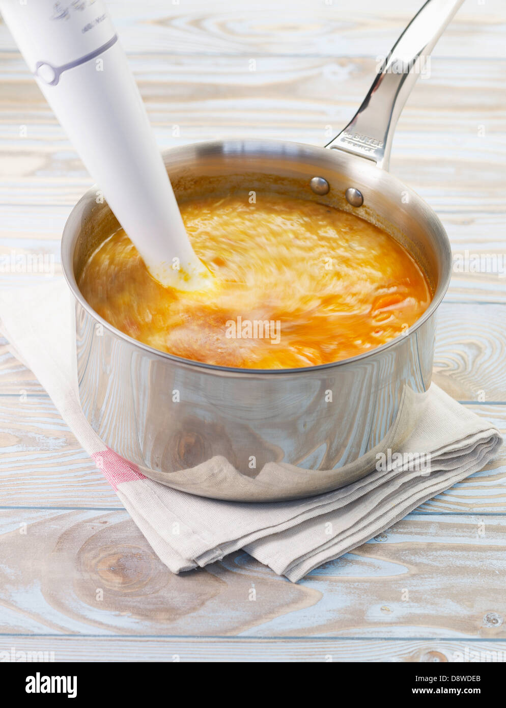 Mixing the soup with a blender Stock Photo, Royalty Free Image