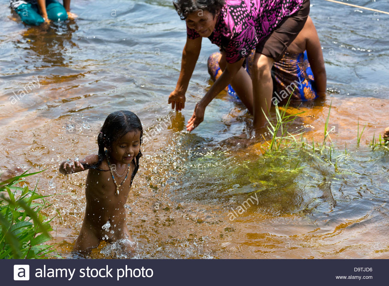 Local People taking a Bath in the River at the Teuk Chhou Rapids in