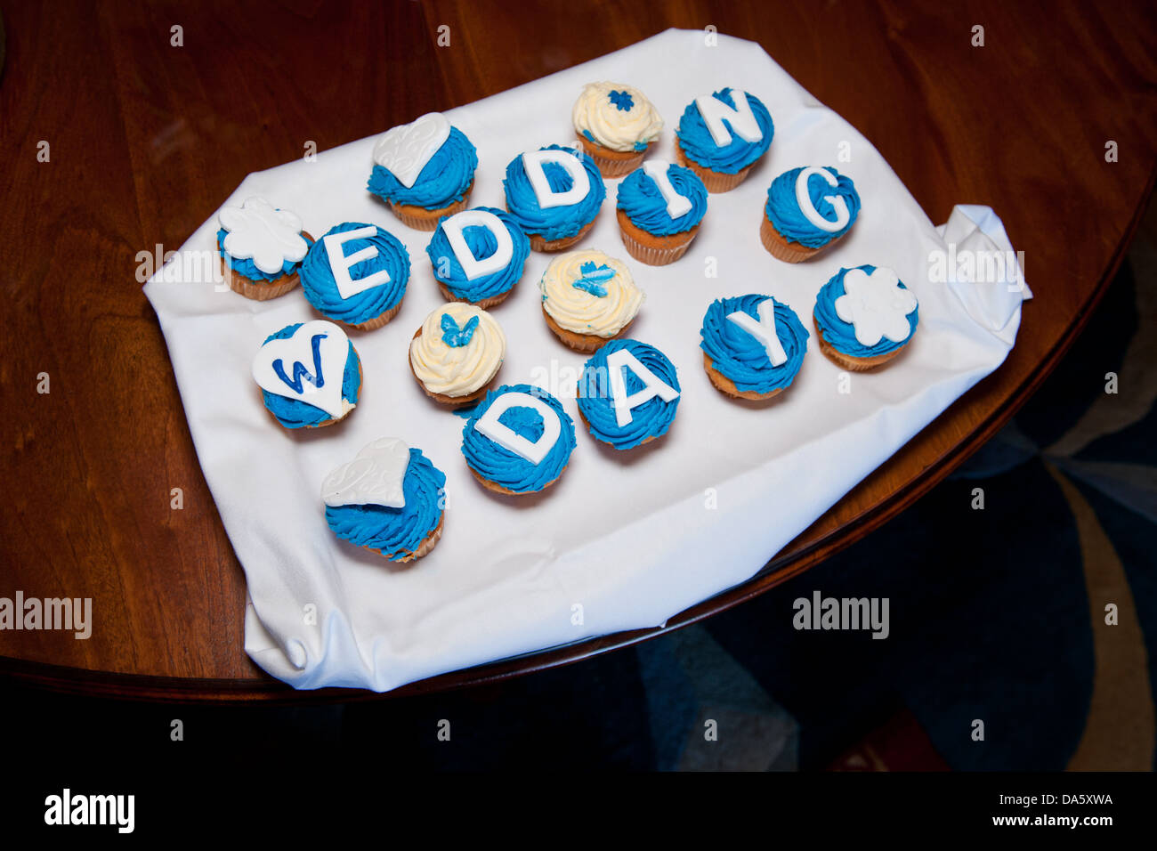 Blue Frosted Iced Wedding Cupcakes That Spell Out The Word Day With Love Heart And Butterfly Cake Toppers Blue Frosted Iced Wedding Cupcakes That Spell Out The Word Day With Love Heart And Butterfly Cake Toppers