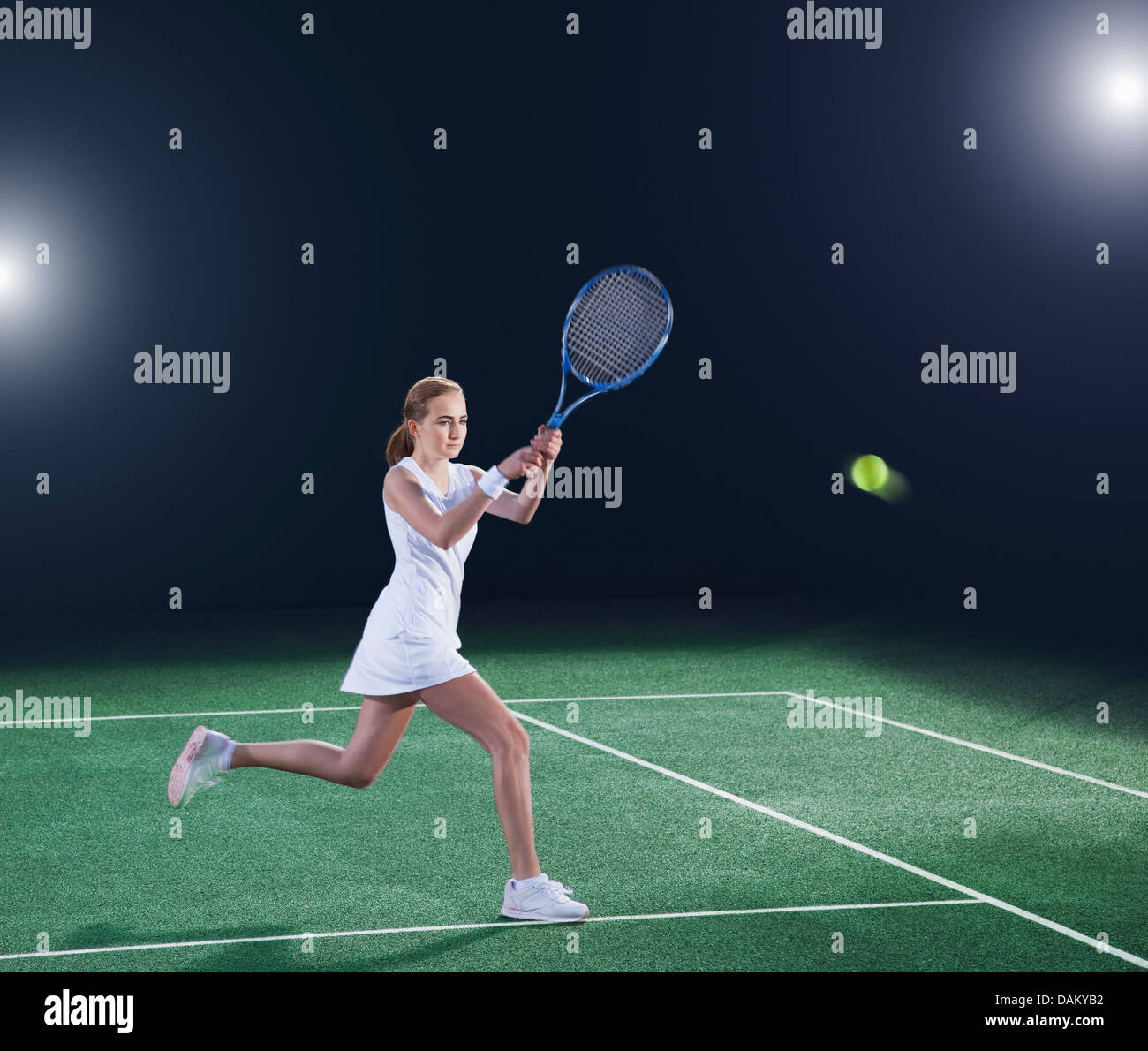 Tennis player hitting ball on court Stock Photo, Royalty Free Image