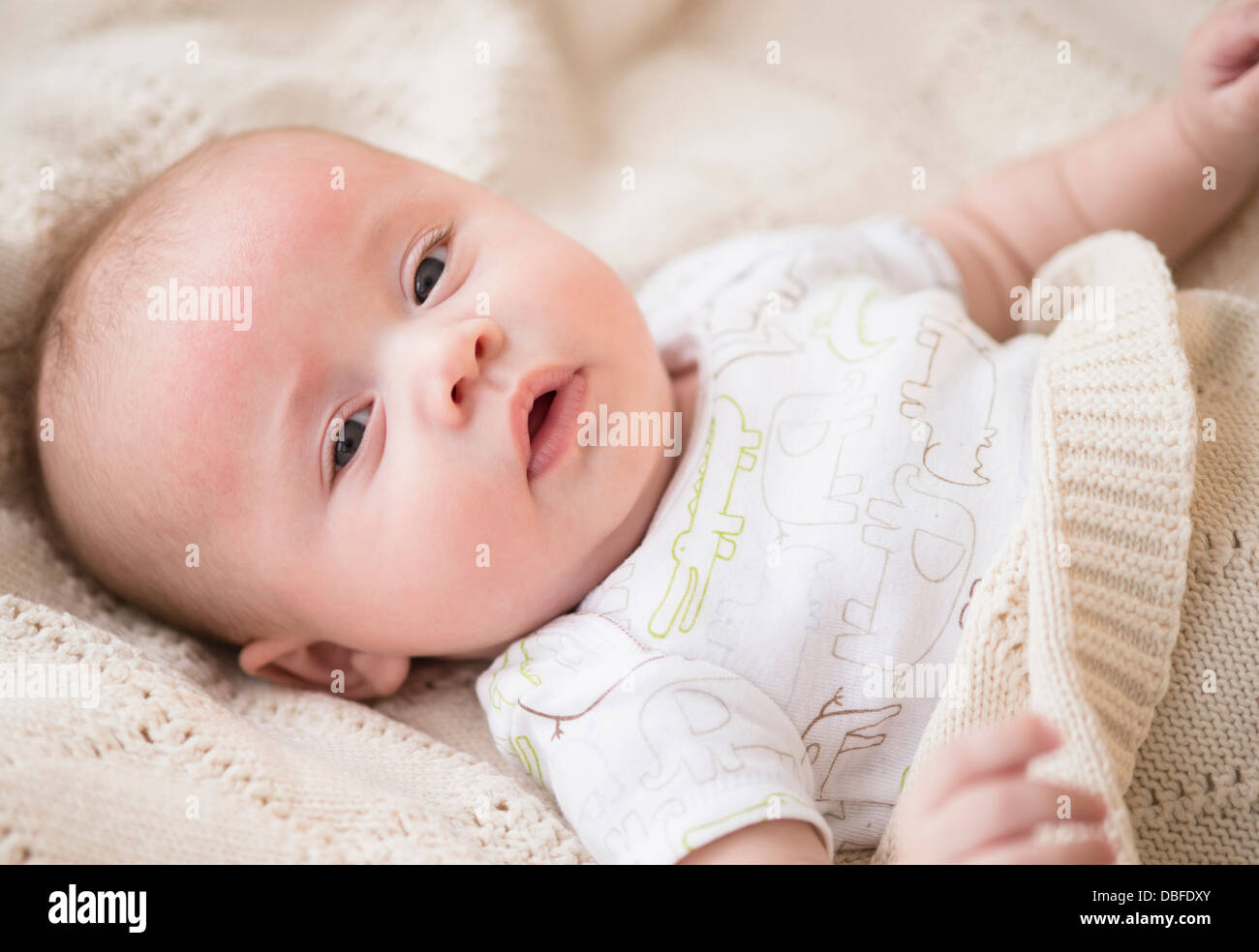 Caucasian Baby Laying On Bed Stock Photo Alamy