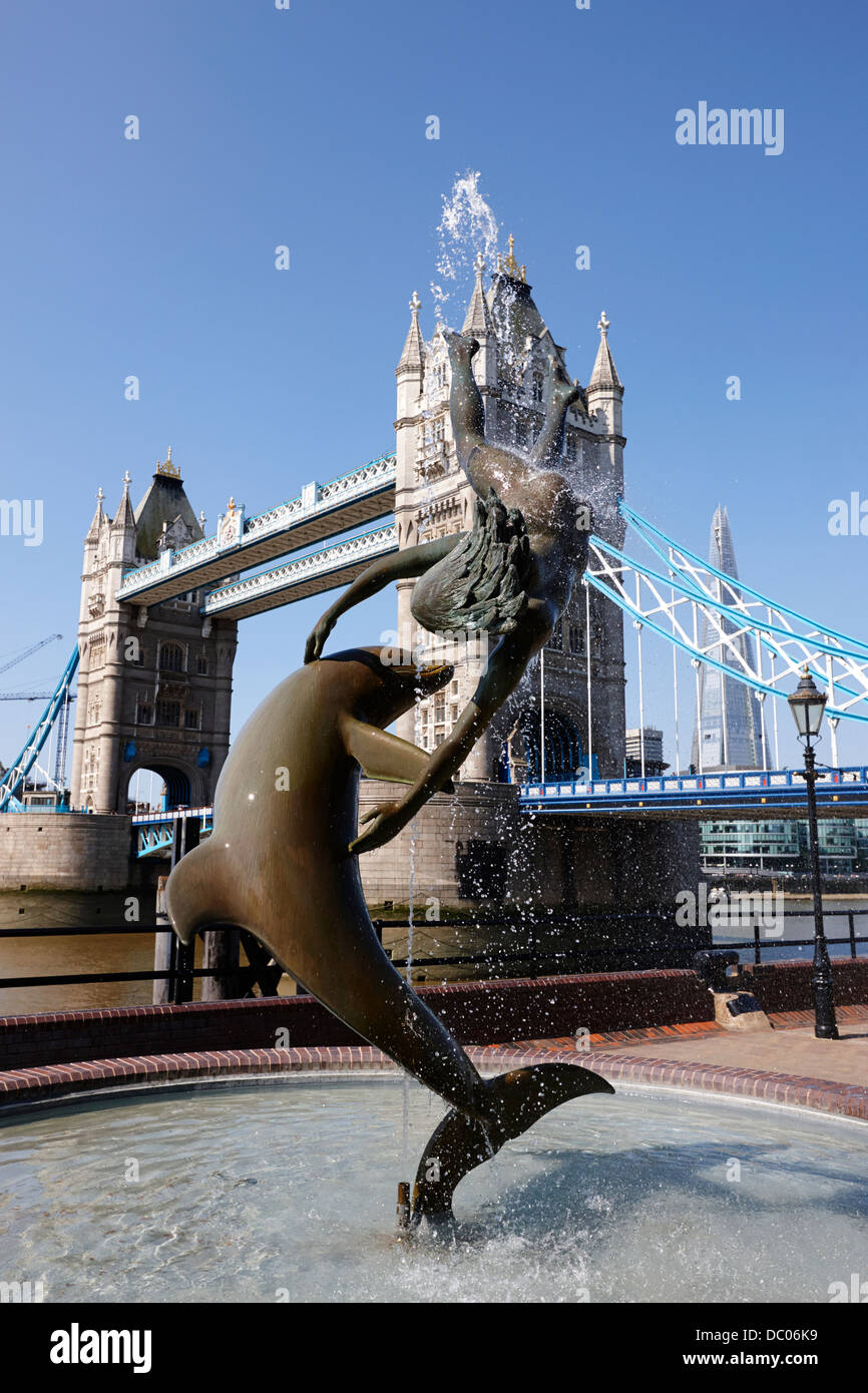 david wynnes girl with a dolphin statue in front of tower bridge Stock