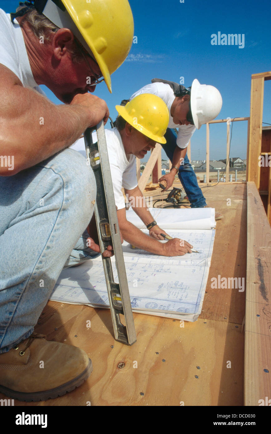 Jobsite foreman giving instructions to carpenters on school Stock Photo