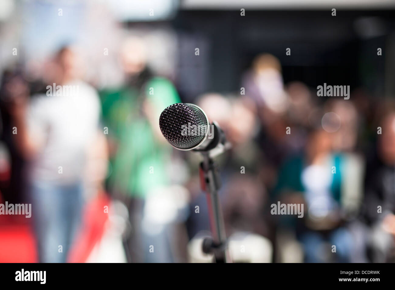 microphone-in-focus-against-blurred-audi