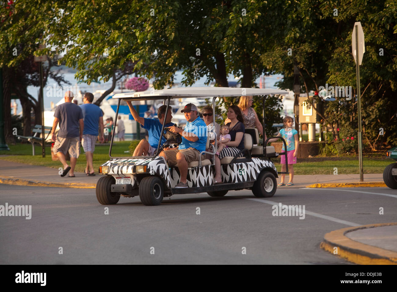 A Man Drives A Golf Cart In Downtown Put In Bay On South A Man Drives A Golf Cart In Downtown Put In Bay On South