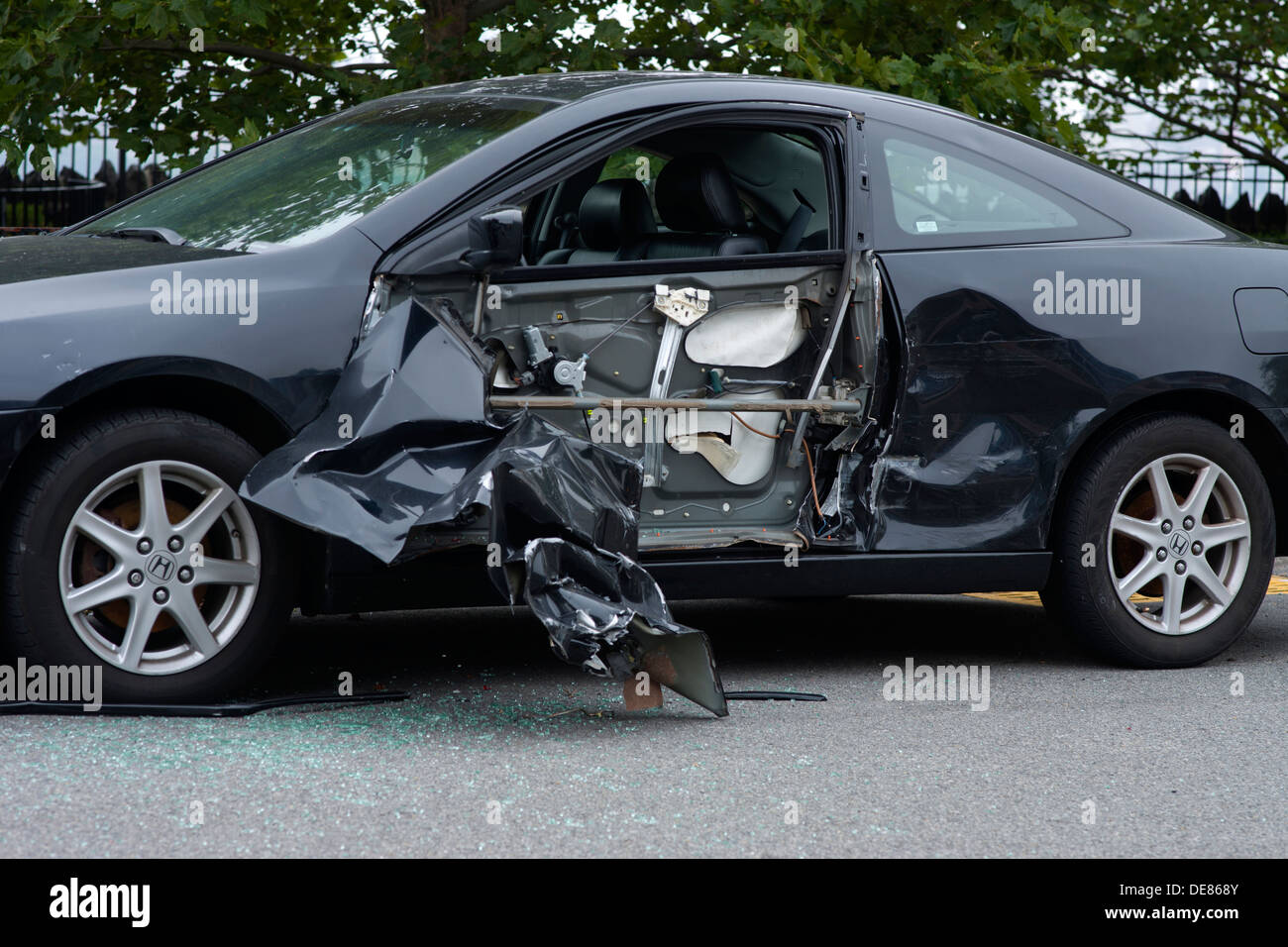 PARKED CRASHED AUTOMOBILE DAMAGED BY SIDESWIPE COLLISION ON CURVE OF Stock Photo, Royalty Free