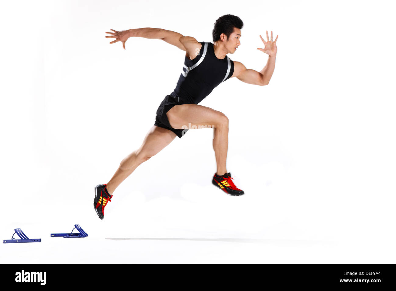 Male runner in starting blocks, side view Stock Photo, Royalty Free