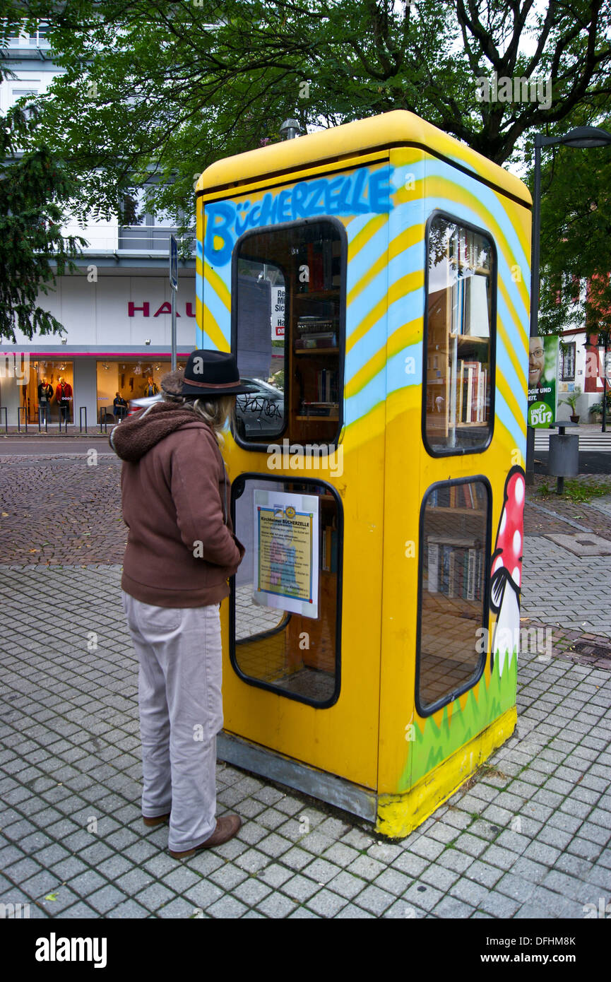 a-woman-looking-into-a-telephone-box-tur