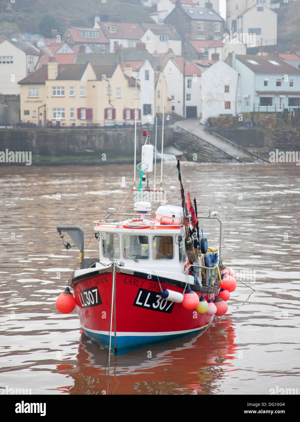 A fishing boat in the harbour at Staithes on the Yorkshire coast Stock