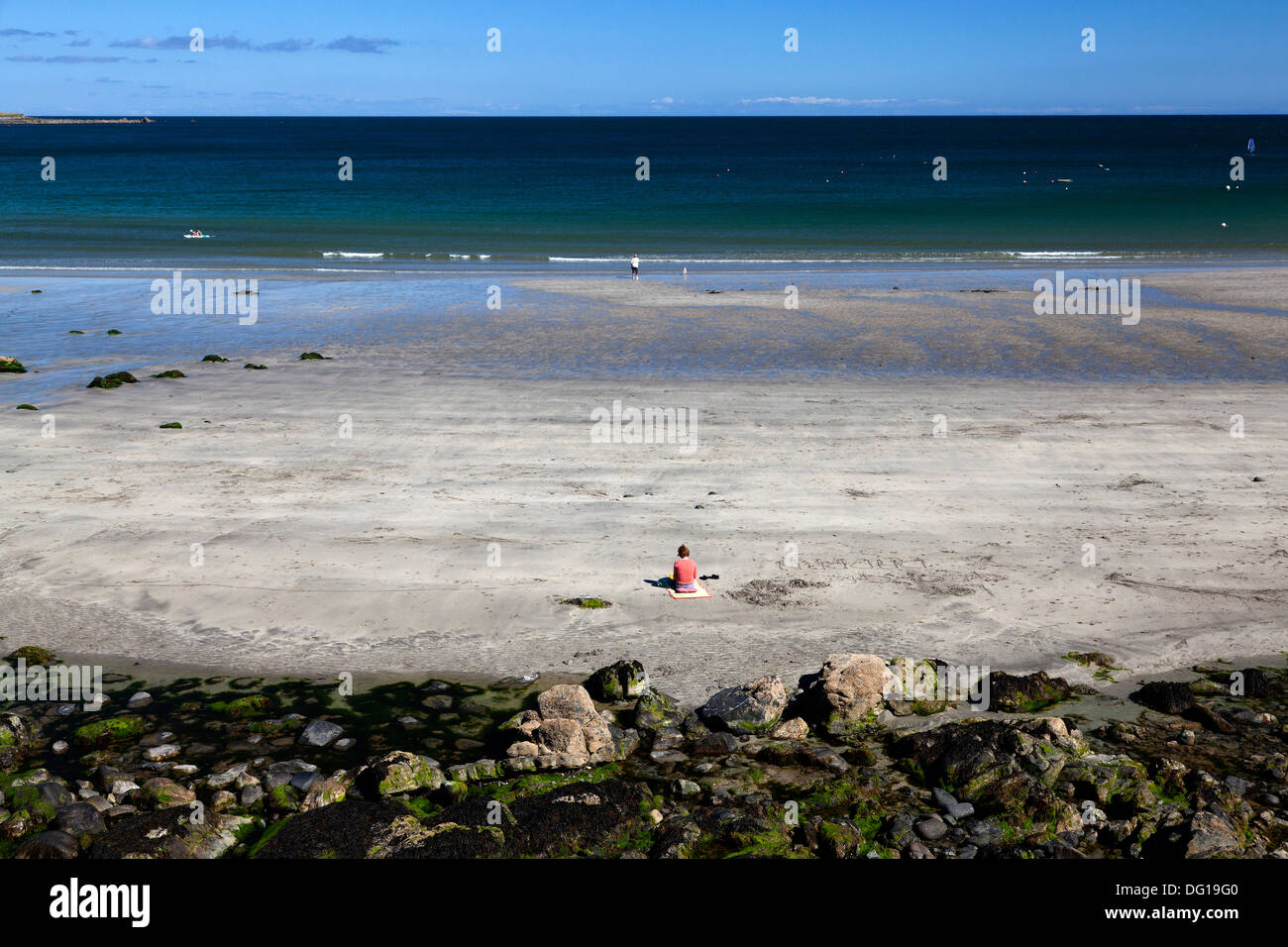 solitary-woman-sitting-on-the-beach-cove