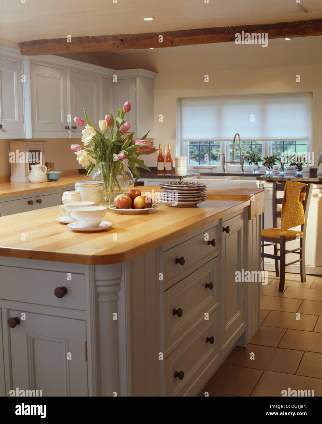 White Kitchen Units With Grey Worktop white kitchen units wood worktop vase of tulips on island unit White Kitchen Units With Grey Worktop white kitchen units wood worktop vase of tulips on island unit