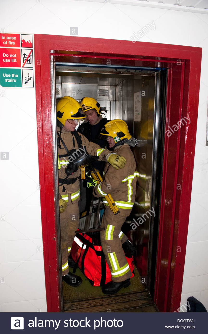 Firefighters using lift in high rise flats fire Stock Photo, Royalty