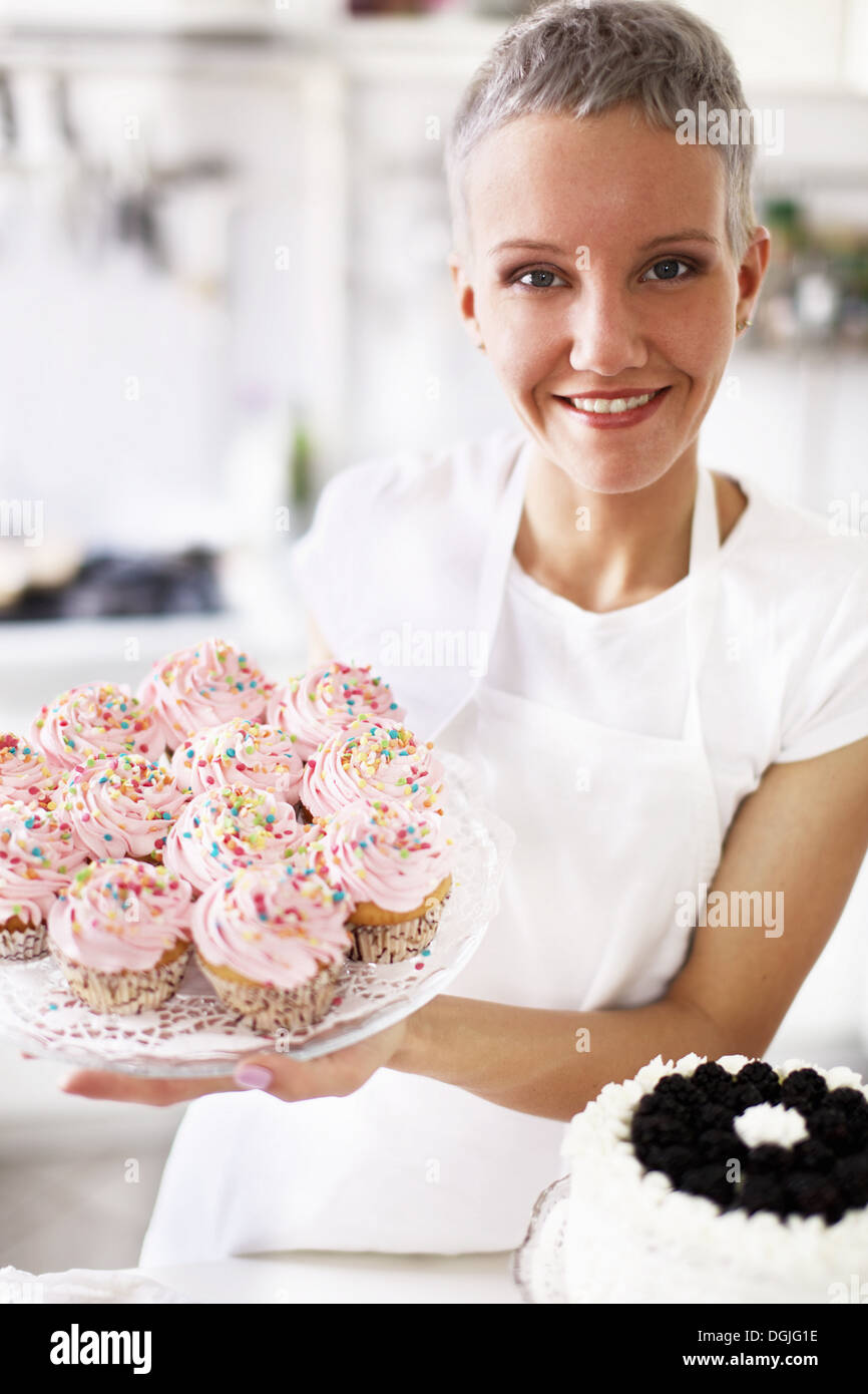 Woman Decorating Cupcakes portrait of woman holding hand made cupcakes stock photo, royalty Woman Decorating Cupcakes portrait of woman holding hand made cupcakes stock photo, royalty