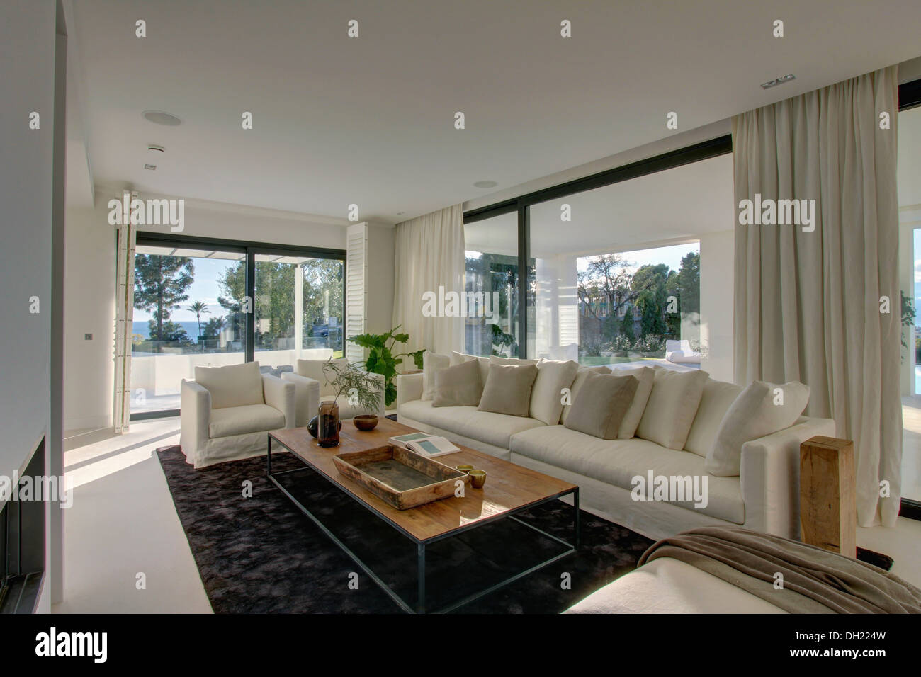 large white settee with white cushions in spanish living room with large white settee with white cushions in spanish living room with