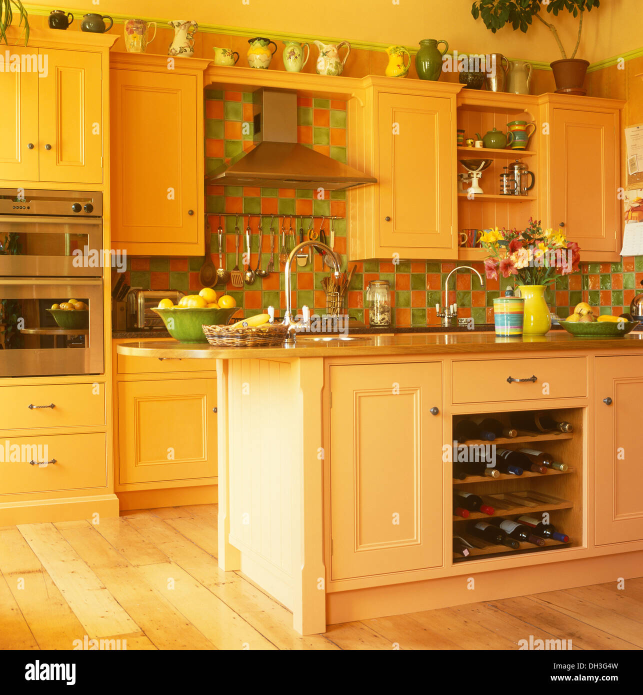 Pale Orange Kitchen green+orange tiles and island unit with integral wine storage in Pale Orange Kitchen green+orange tiles and island unit with integral wine storage in