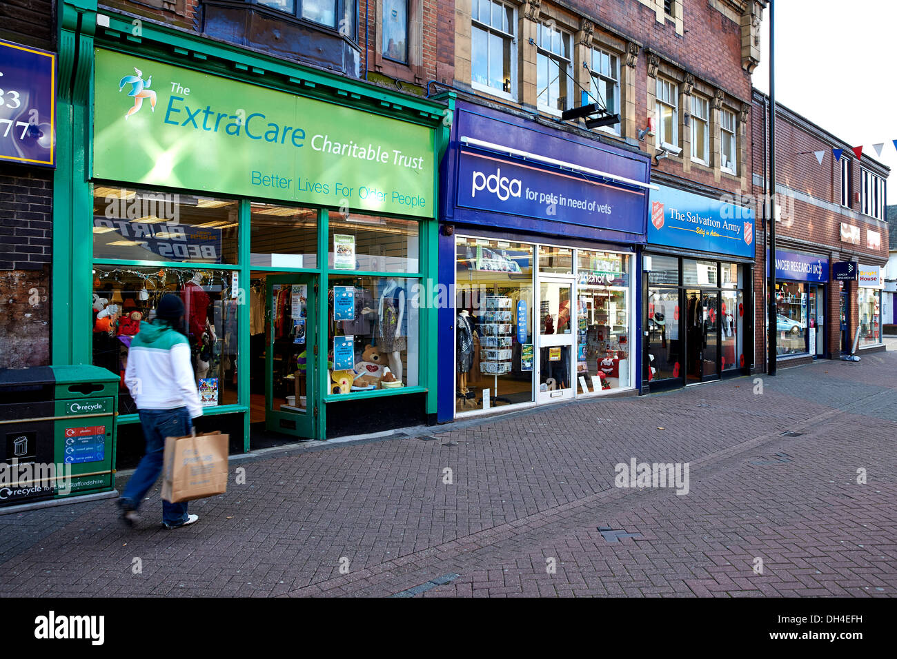 4-charity-shops-in-a-row-on-a-high-street-in-the-uk-stock-photo