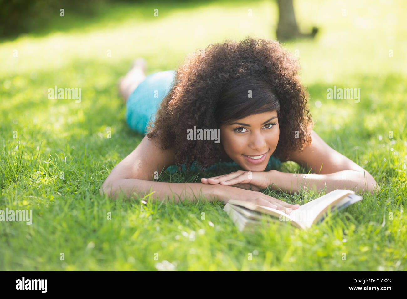 Gorgeous Smiling Brunette Lying On Grass Reading Book Stock Photo Alamy