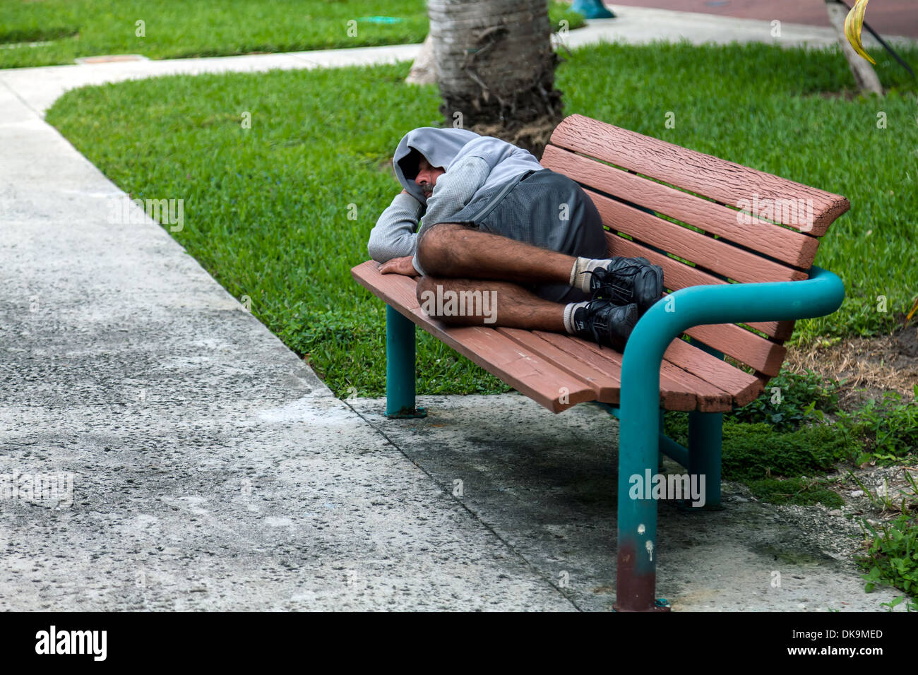 A Homeless Man Sleeping On A Park Bench In Downtown Fort Lauderdale