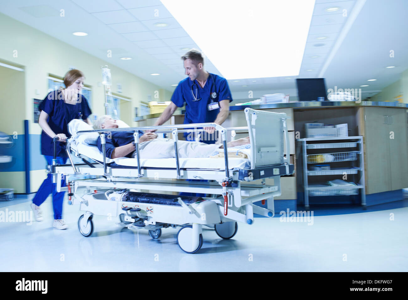 Two medics rushing with gurney in hospital emergency room Stock Photo