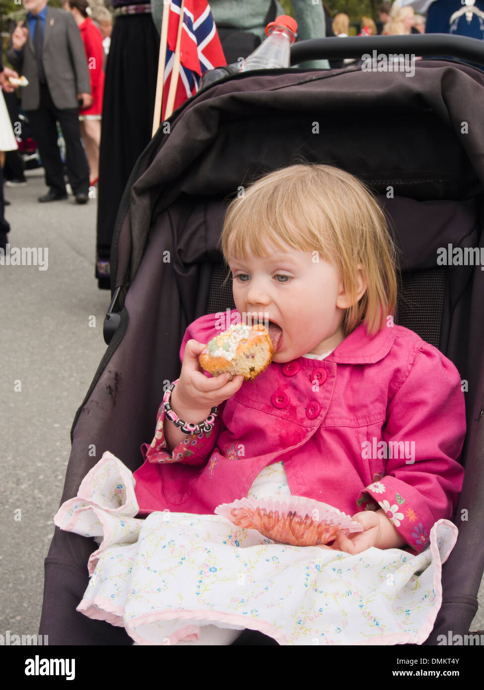 toddler-girl-in-pram-eating-a-muffin-pre