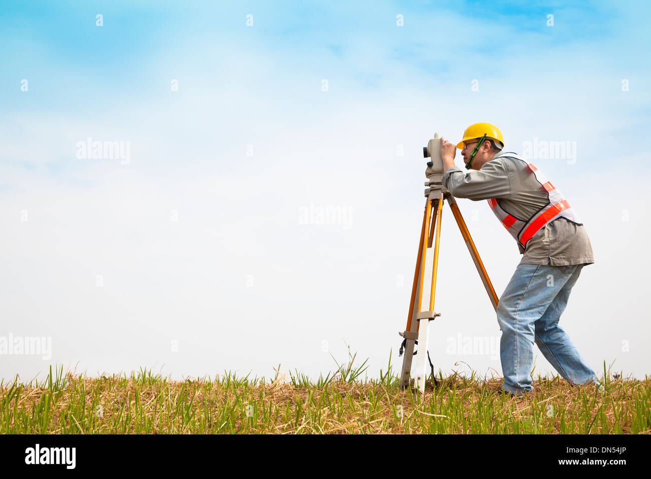 Surveyor engineer making measure on the field Stock Photo, Royalty Free