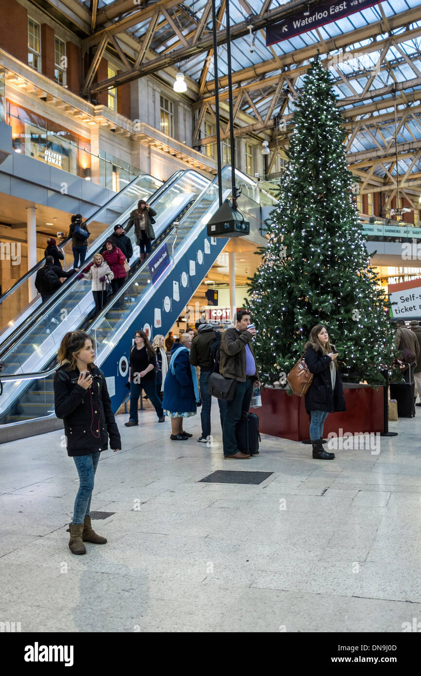 christmas tree at waterloo station and people waiting for christmas tree at waterloo station and people waiting for