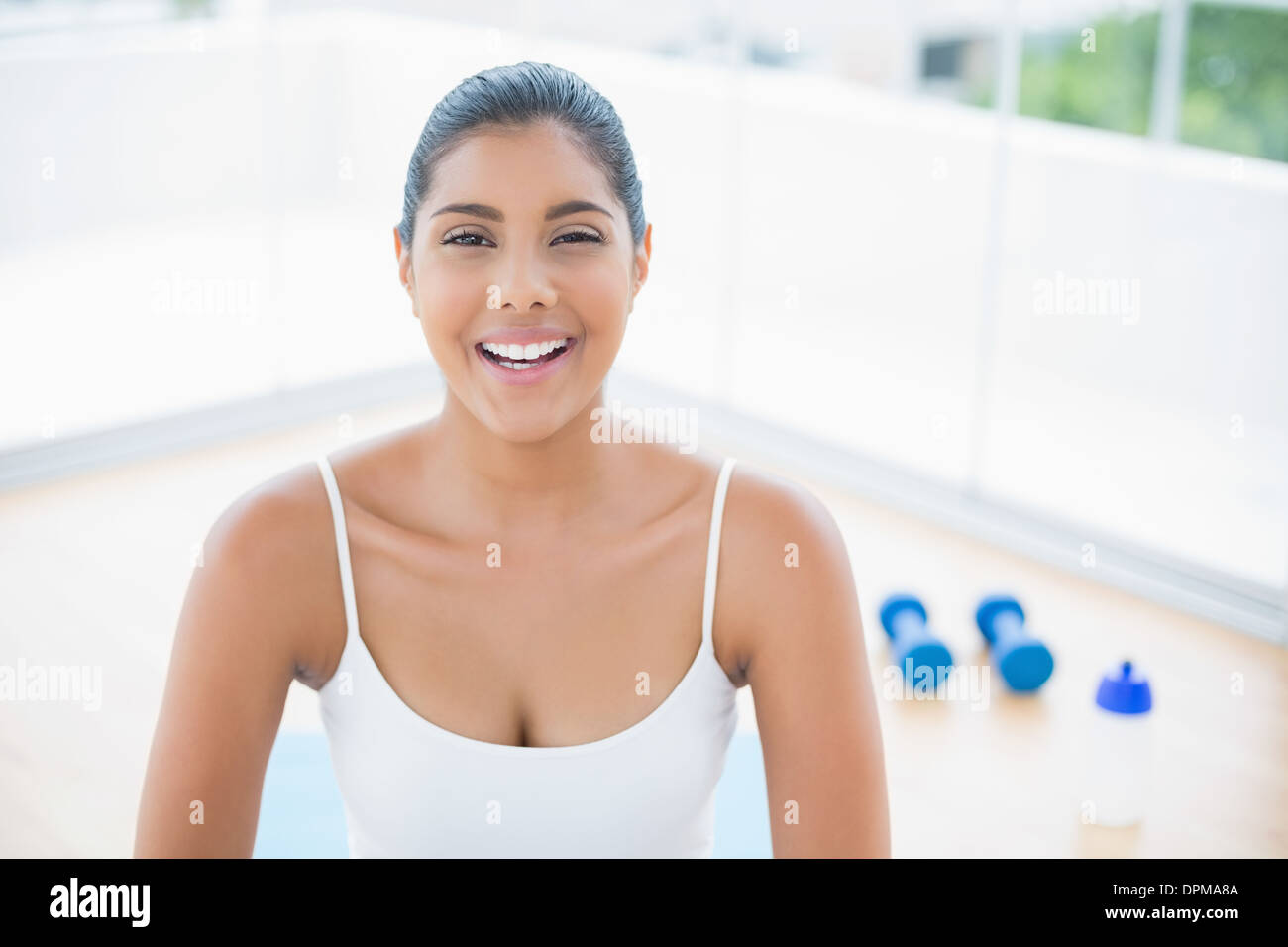 Cheerful Toned Brunette Sitting On Floor Stock Photo Alamy