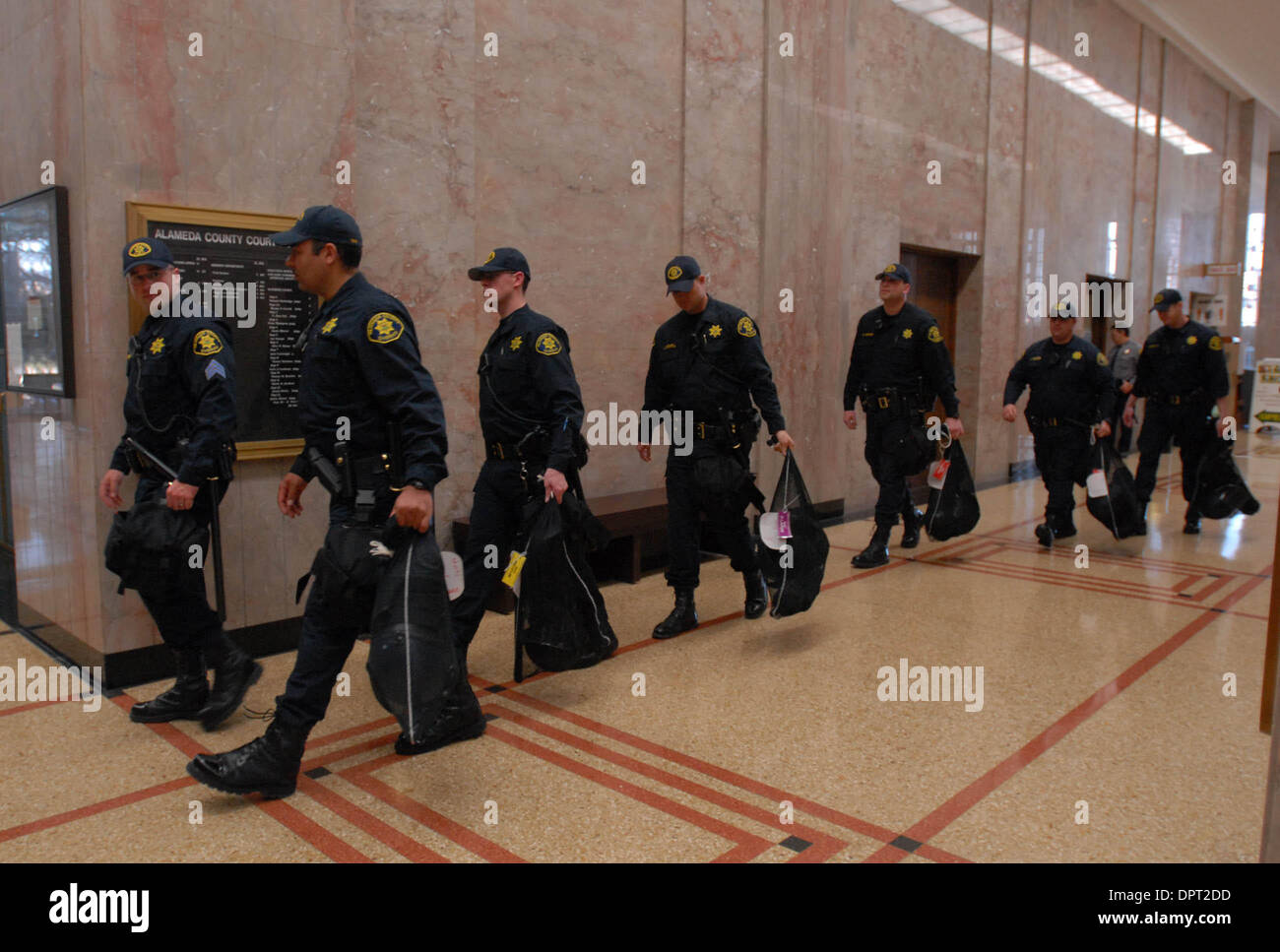 Alameda County Sheriff deputies exit the courthouse with their riot