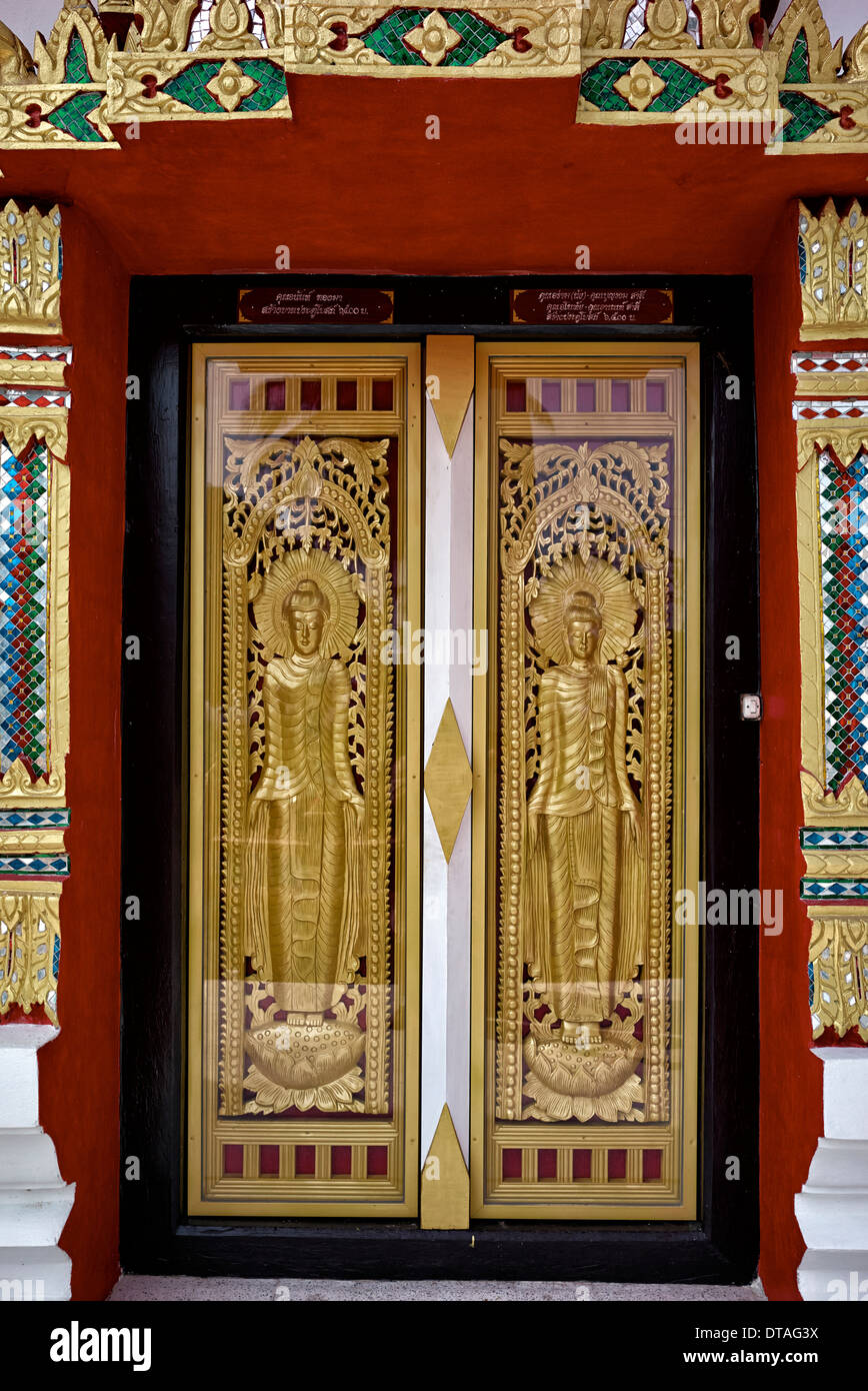 Ornate Thai Buddhist temple entrance doors with glass encased golden